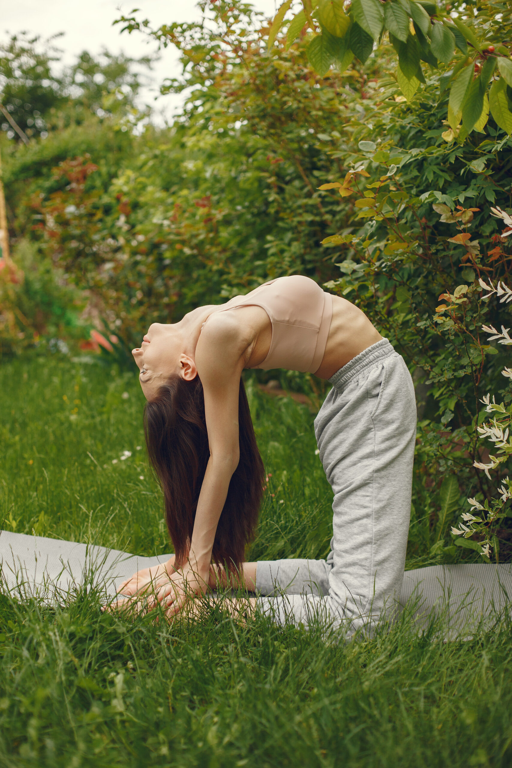 woman practicing advanced yoga park 1 scaled